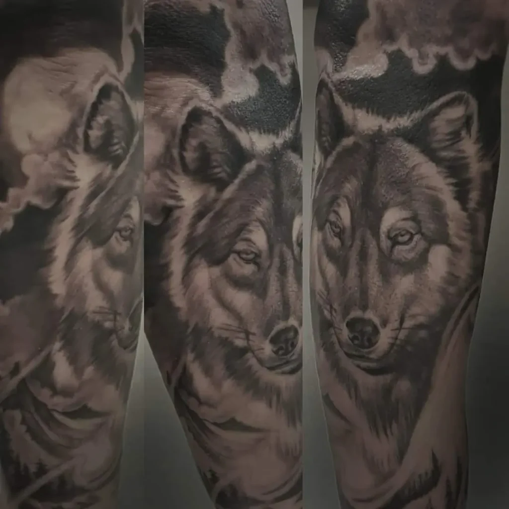 black and grey wolf tattoo with mountains